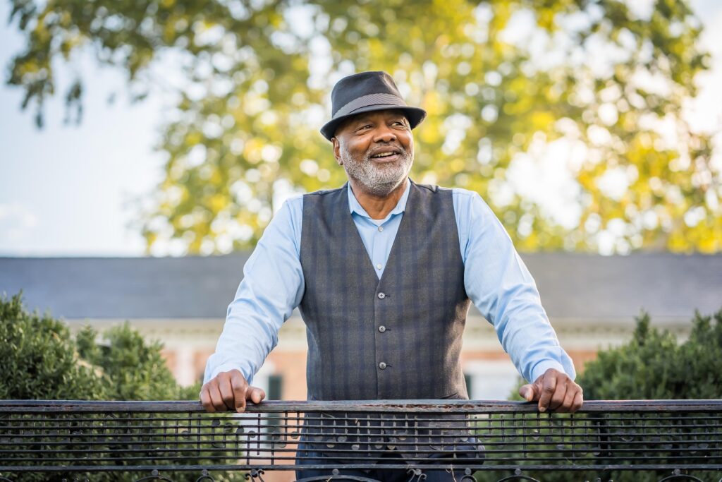 Older man reviewing their retirement savings goals with calculator and financial documents.